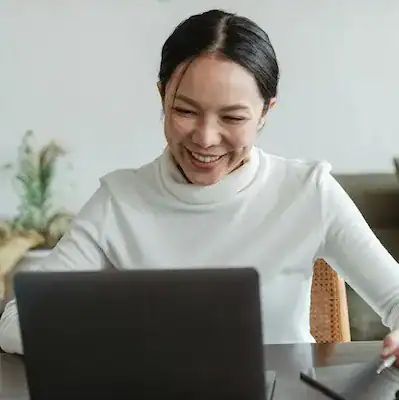 woman smiling at laptop